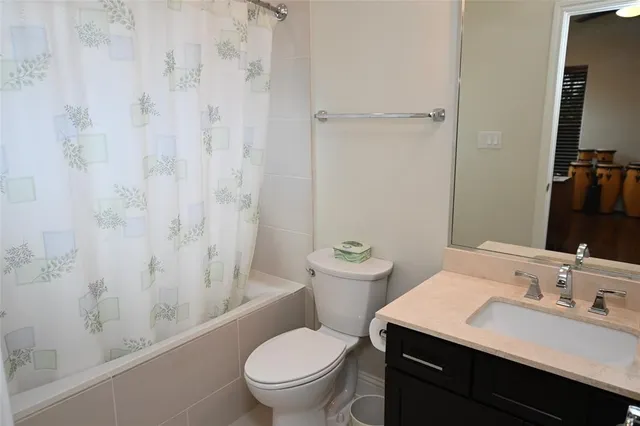 a bathroom with a sink toilet vanity and shower
