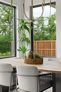 a potted plant sitting on a table next to a yard
