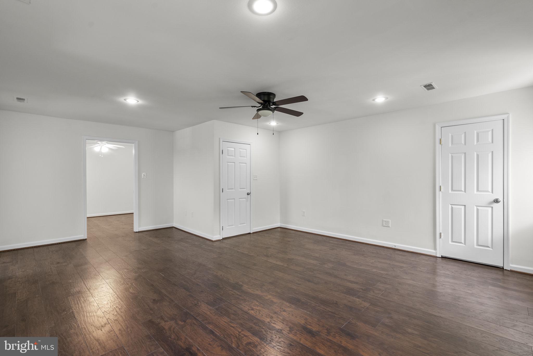 24000 Clarksburg Road Clarksburg, MD 20871 - Photo 24 of 60 an empty room with wooden floor and a ceiling fan