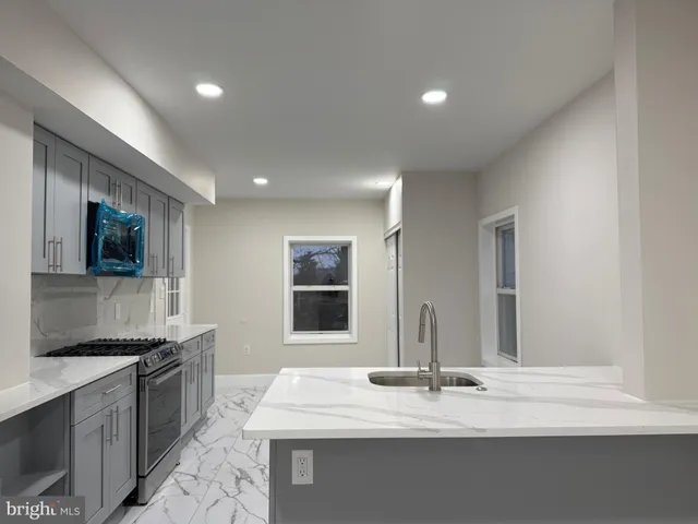 a kitchen with a sink stove and refrigerator