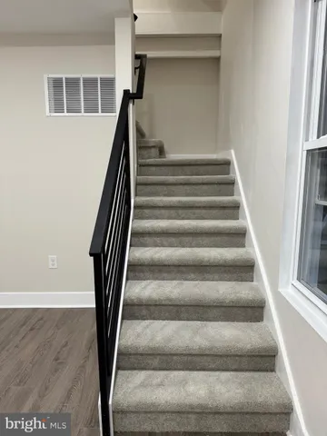 a view of staircase with white walls