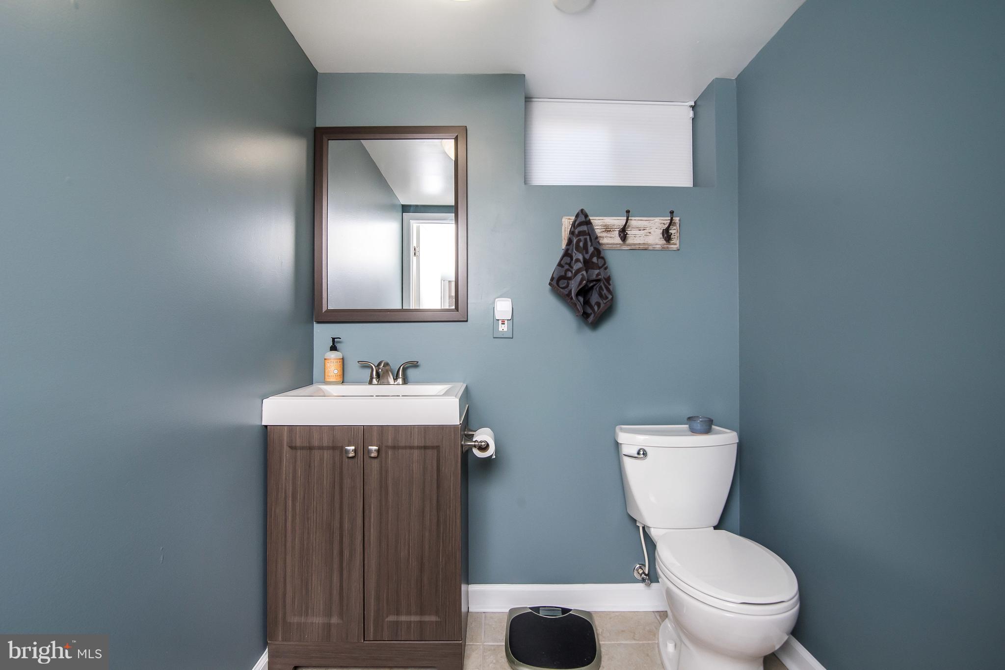 4042 High Point Road Ellicott City, MD 21042 - Photo 24 of 29 a bathroom with a toilet a sink and mirror