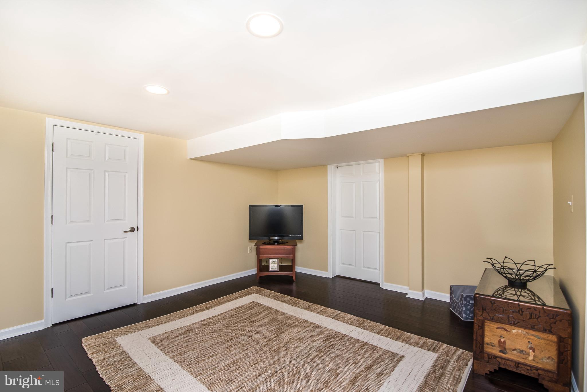 4042 High Point Road Ellicott City, MD 21042 - Photo 25 of 29 a bedroom with a bed and wooden floor