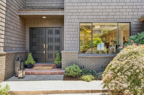 a view of a brick house with a large windows