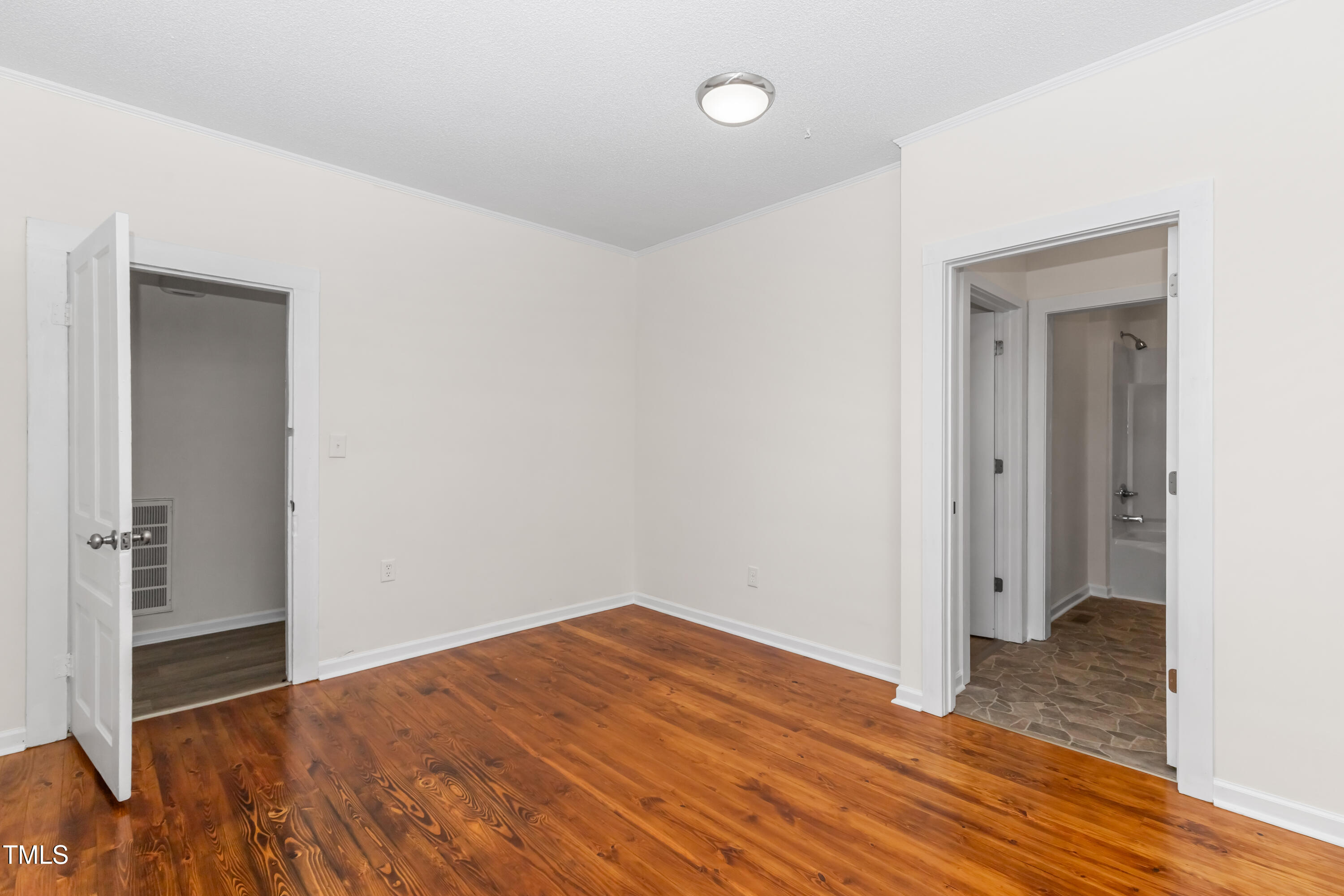 726 West M Street Erwin, NC 28339 - Photo 14 of 26 a view of a room with wooden floor and closet