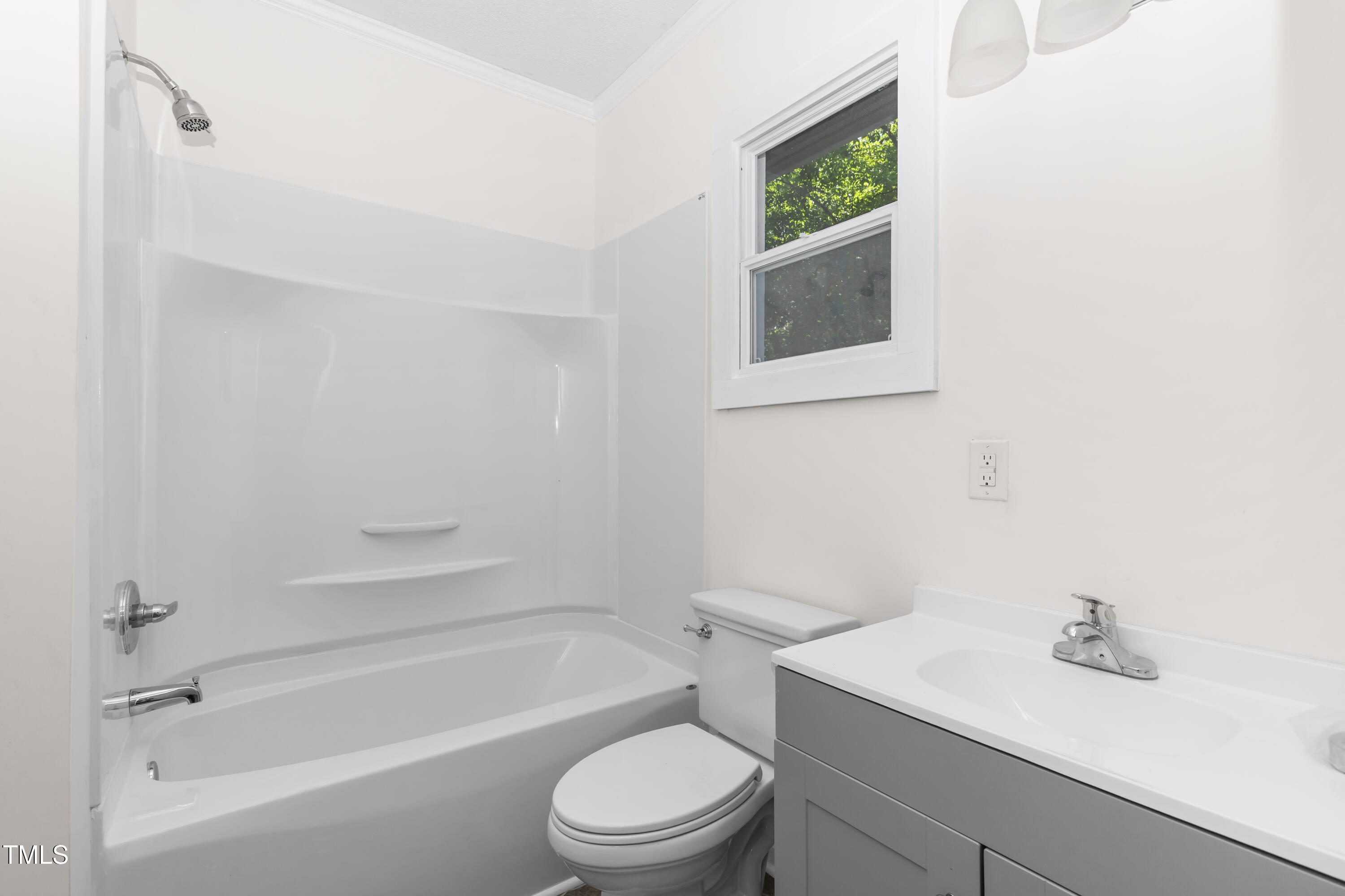 726 West M Street Erwin, NC 28339 - Photo 15 of 26 a bathroom with a toilet a sink and bathtub