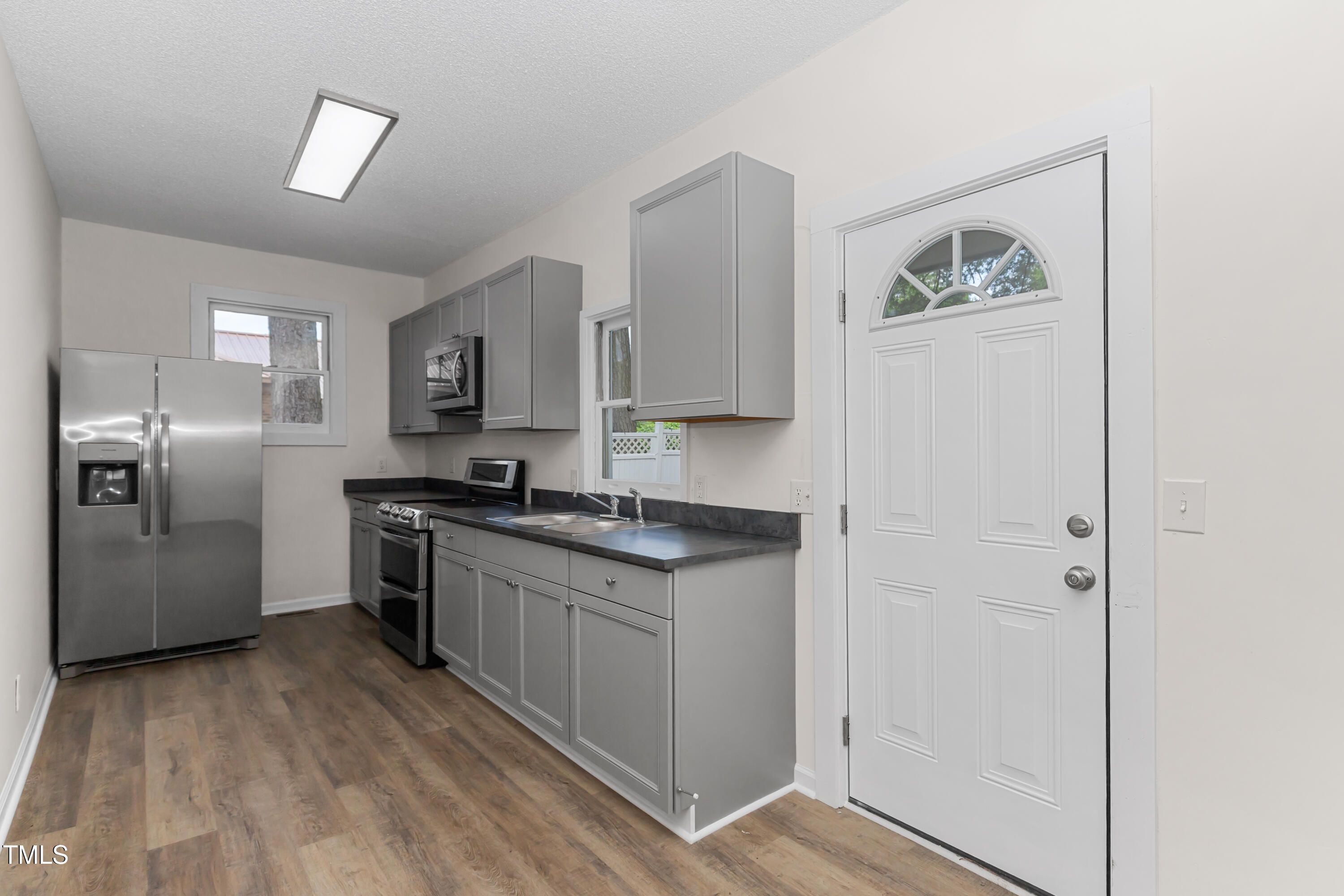 726 West M Street Erwin, NC 28339 - Photo 18 of 26 a kitchen with stainless steel appliances granite countertop a refrigerator and a stove