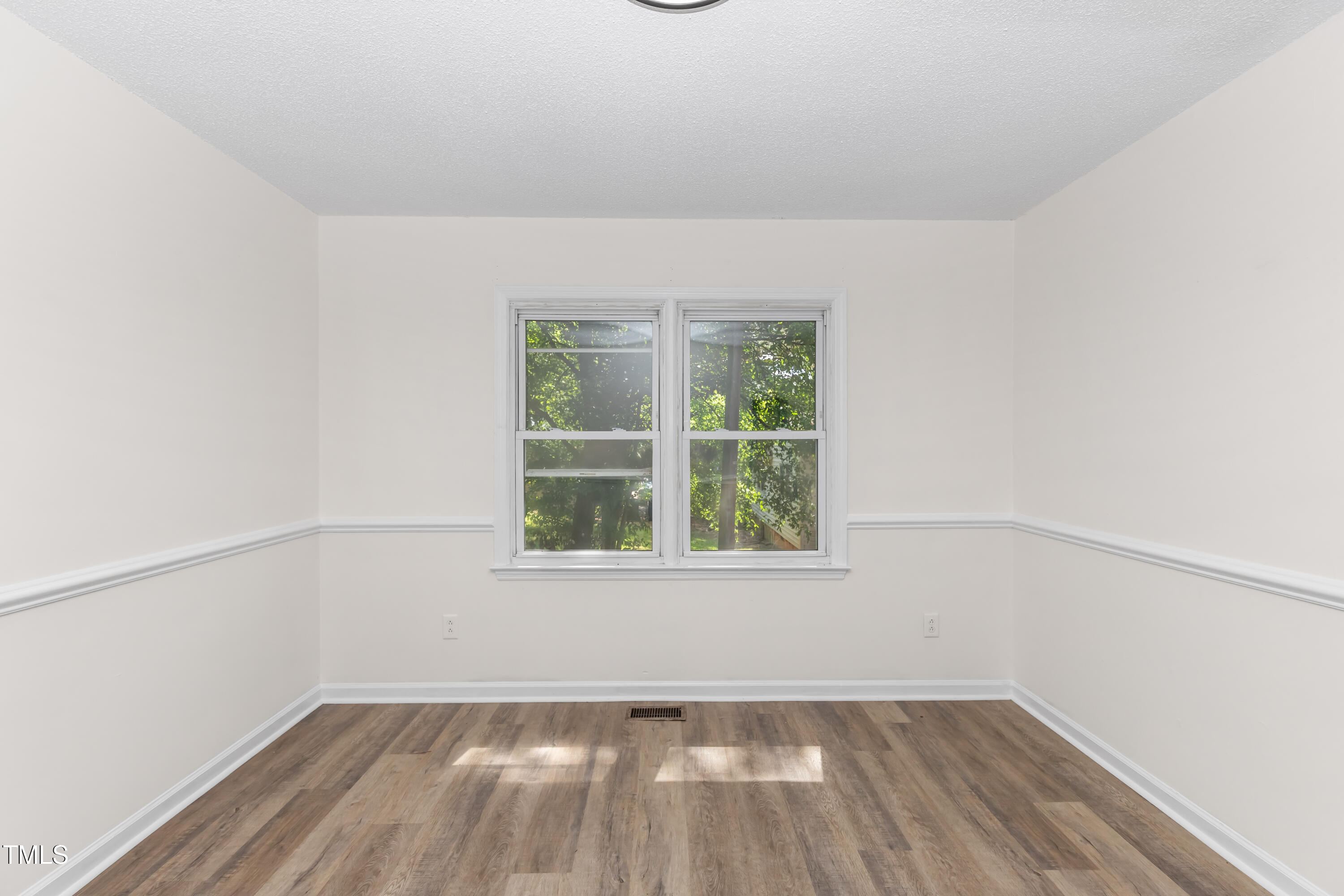 726 West M Street Erwin, NC 28339 - Photo 20 of 26 an empty room with a window