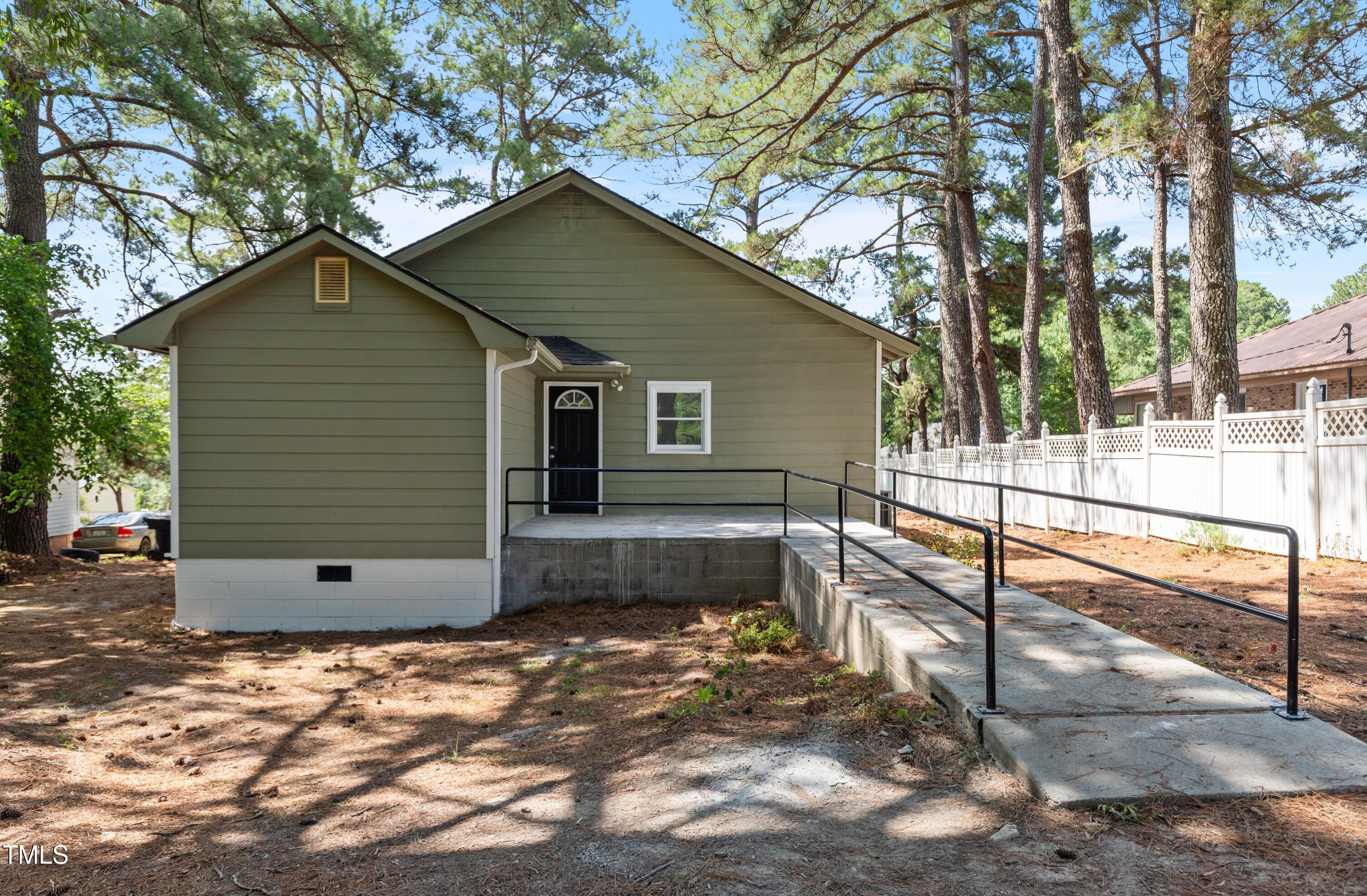 726 West M Street Erwin, NC 28339 - Photo 22 of 26 a view of a small house with a yard