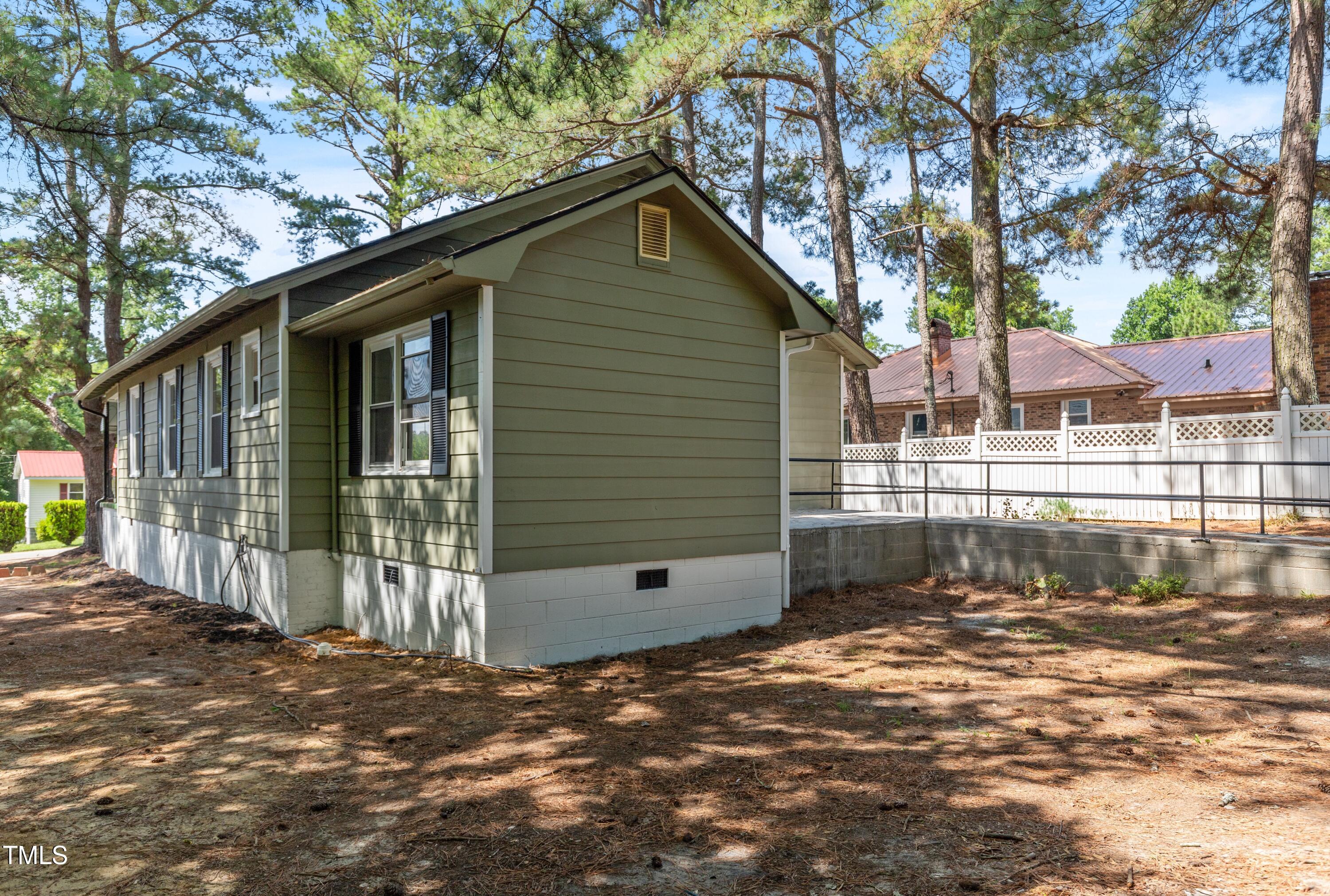 726 West M Street Erwin, NC 28339 - Photo 23 of 26 a front view of a house with a large tree
