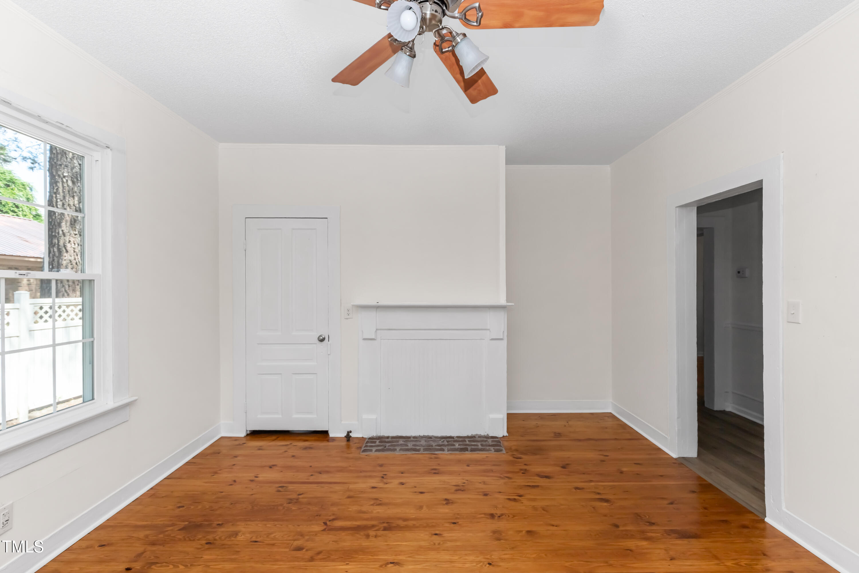 726 West M Street Erwin, NC 28339 - Photo 9 of 26 a view of empty room with window and wooden floor