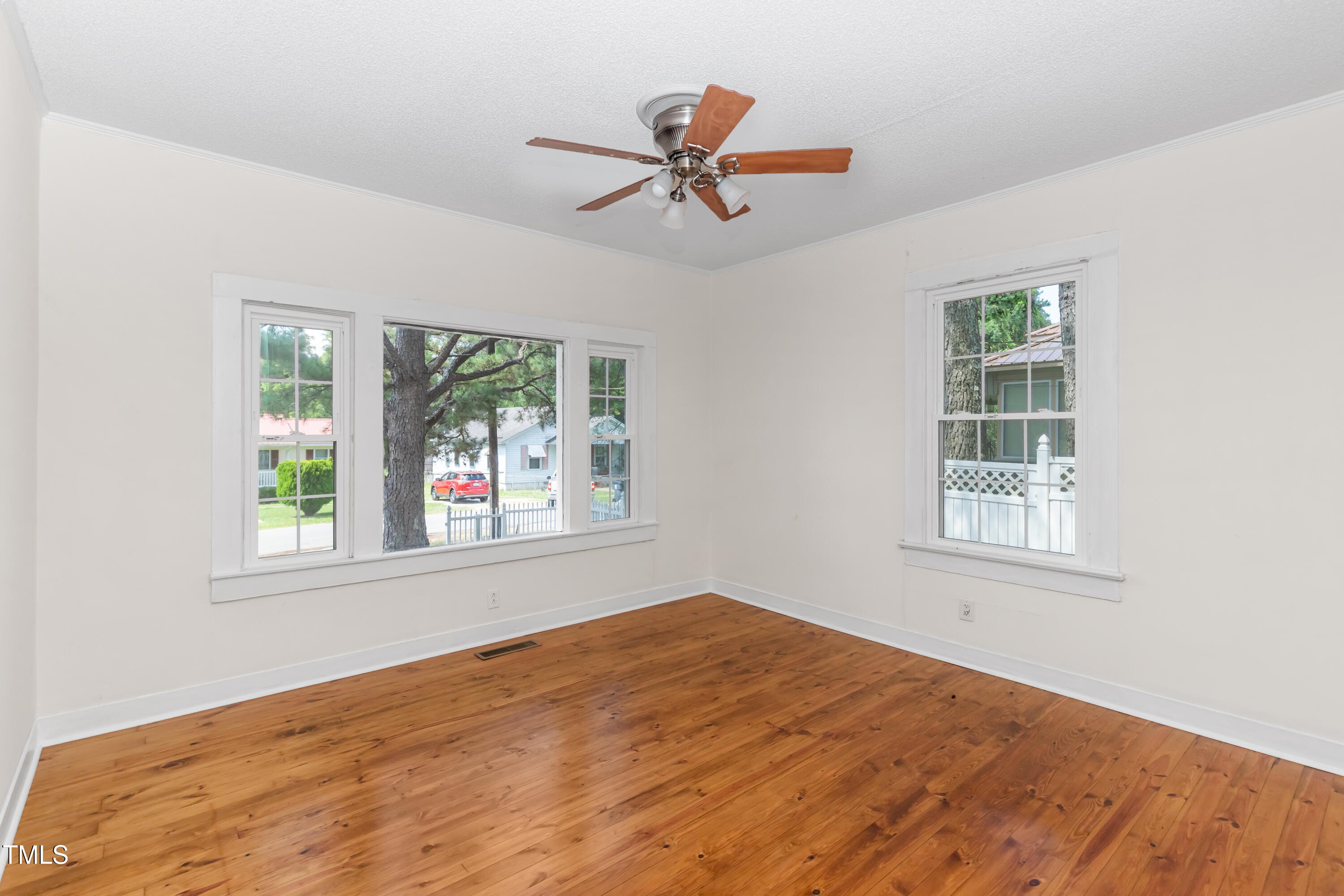726 West M Street Erwin, NC 28339 - Photo 10 of 26 a view of an empty room with wooden floor and a window