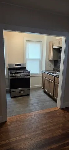 a kitchen with granite countertop a stove and a microwave
