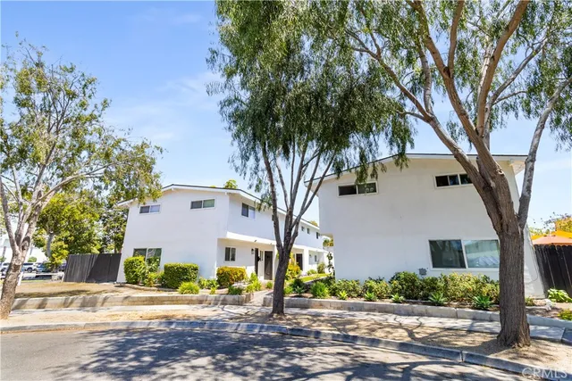 a front view of a house with a tree s
