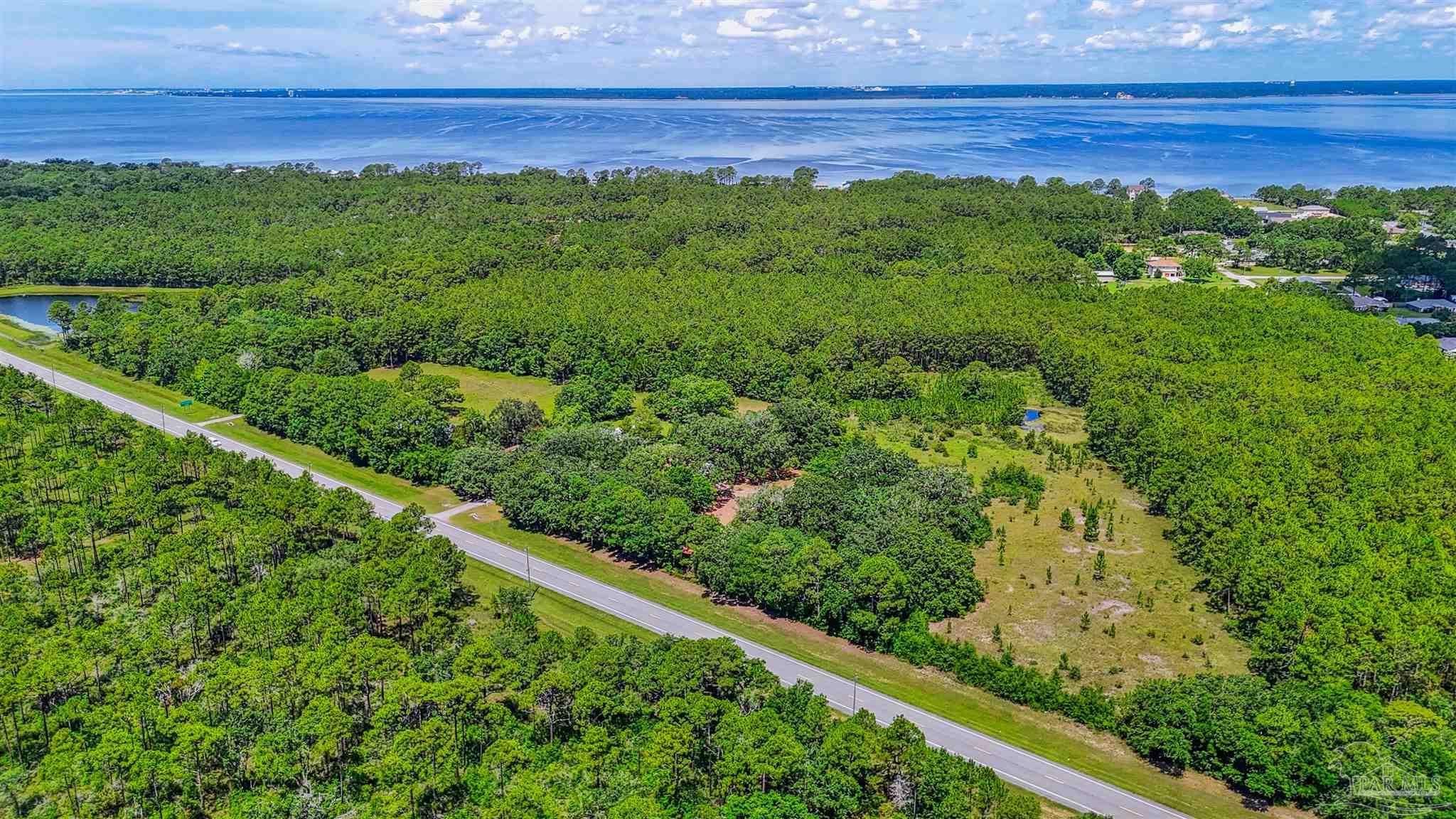 939 Avalon Boulevard Milton, FL 32583 - Photo 14 of 56 a view of a yard with an outdoor space