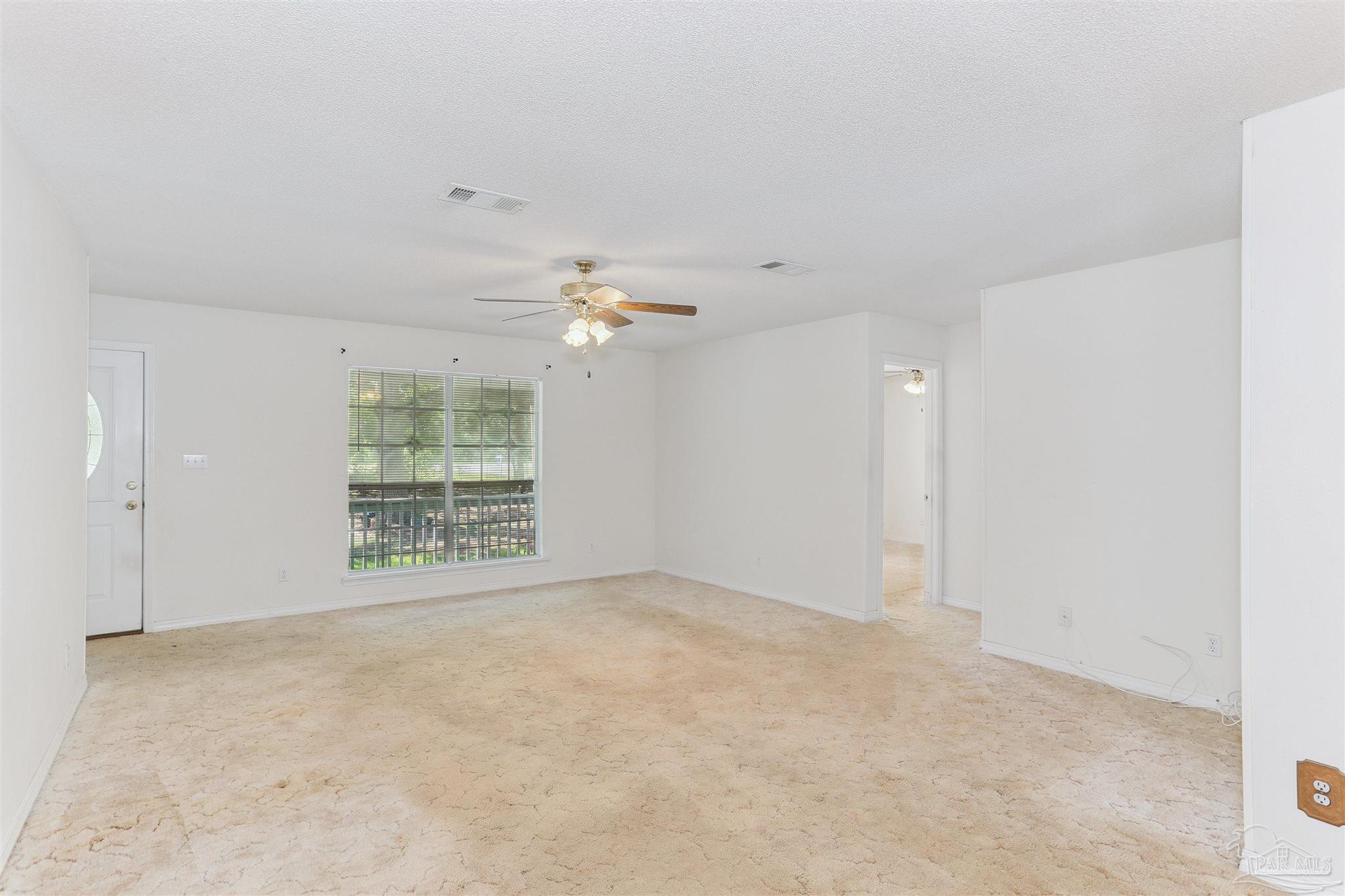 939 Avalon Boulevard Milton, FL 32583 - Photo 24 of 56 an empty room with windows and entrance