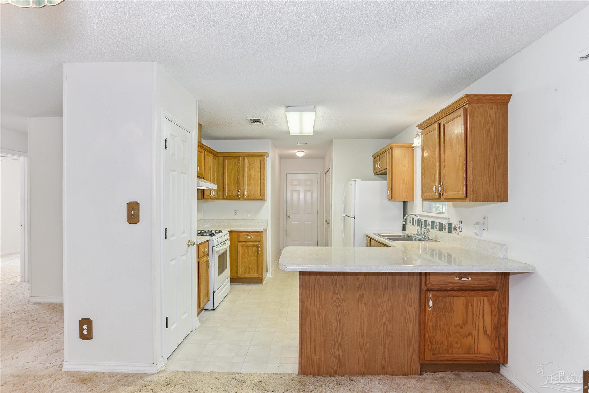 939 Avalon Boulevard Milton, FL 32583 - Photo 27 of 56 a spacious bathroom with a granite countertop sink and a mirror