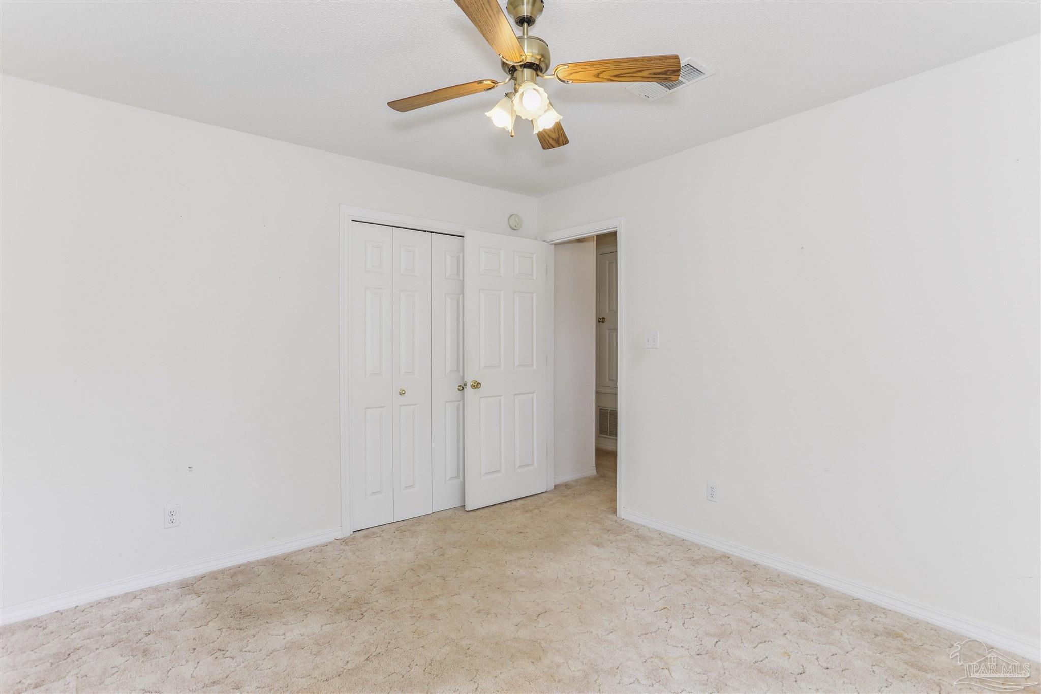 939 Avalon Boulevard Milton, FL 32583 - Photo 32 of 56 a view of a chandelier fan in a room