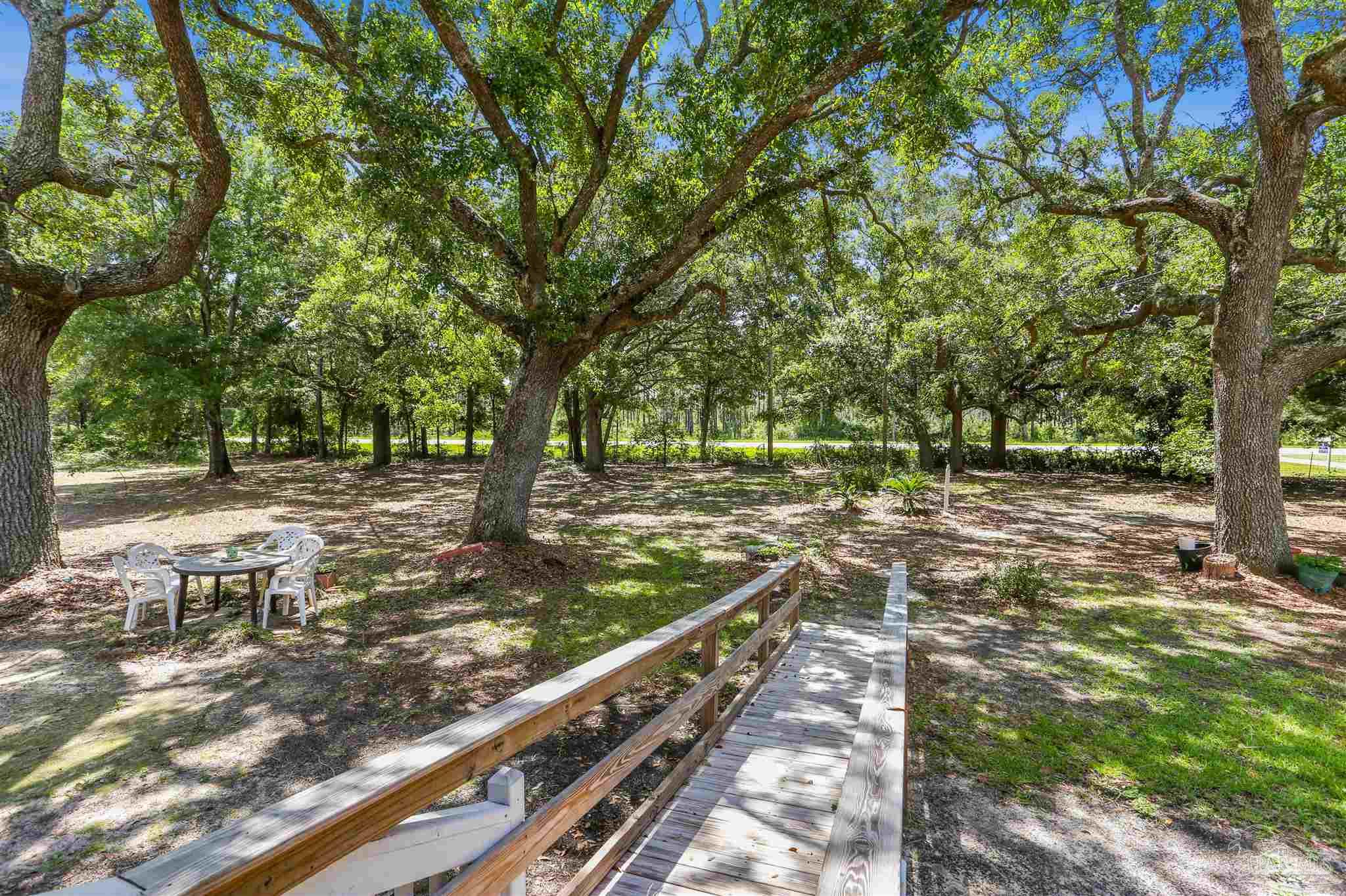 939 Avalon Boulevard Milton, FL 32583 - Photo 42 of 56 a view of a yard with wooden fence