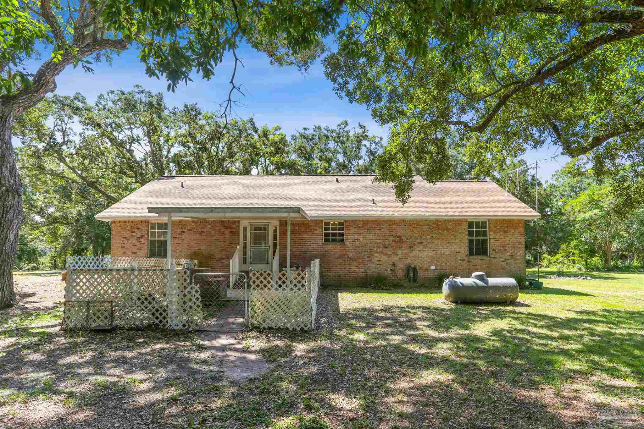 939 Avalon Boulevard Milton, FL 32583 - Photo 43 of 56 a front view of a house with garden