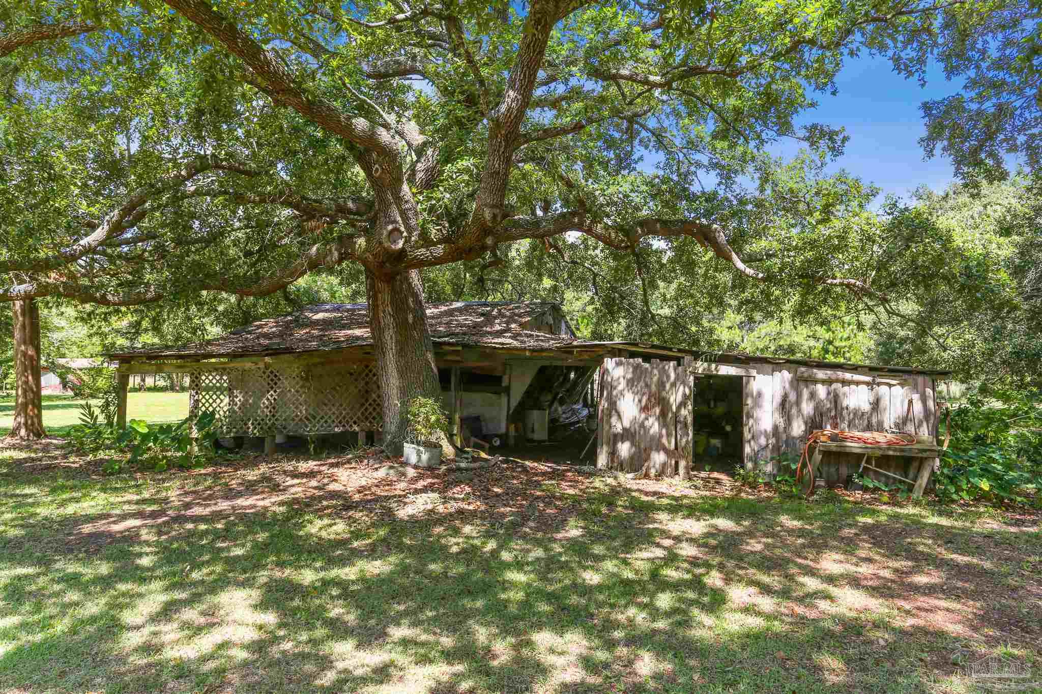 939 Avalon Boulevard Milton, FL 32583 - Photo 45 of 56 front view of a house with a yard