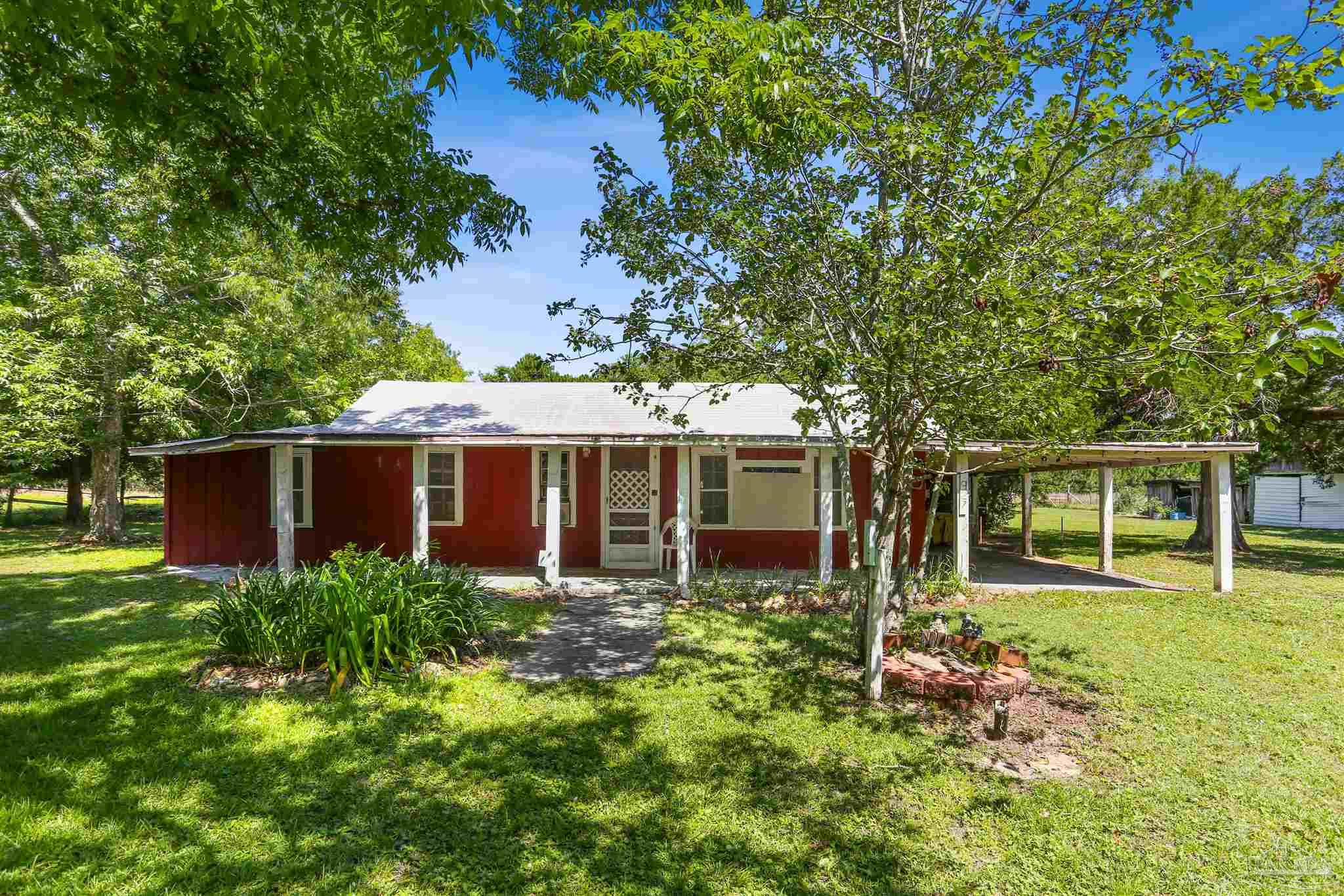 939 Avalon Boulevard Milton, FL 32583 - Photo 47 of 56 front view of a house with a yard