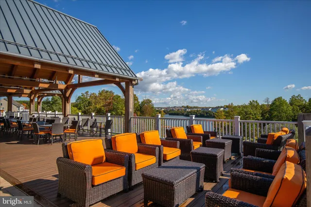 an outdoor living room with patio furniture and city view
