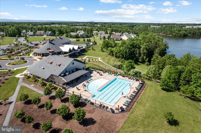an aerial view of a house with a garden and lake view
