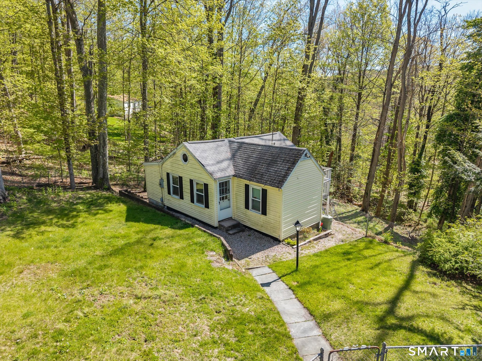 93 Torrington Avenue Canton, CT 06019 - Photo 8 of 24 a view of a house with a large trees pool and sitting area