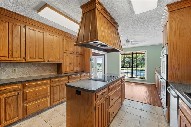 a kitchen with granite countertop a sink and a stove
