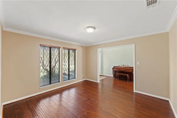 a view of room with window and wooden floor