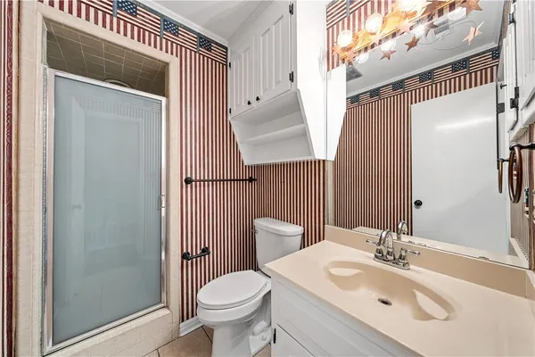 a bathroom with a sink a toilet and shower