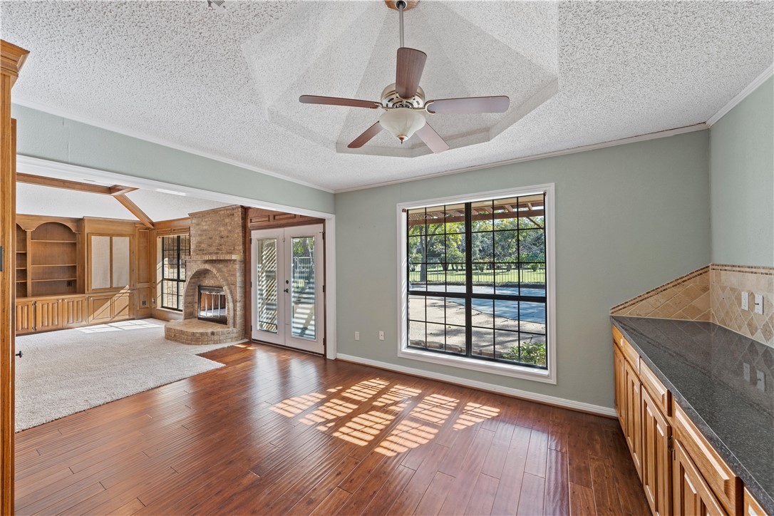 6000 Flat Rock Road Waco, TX 76708 - Photo 10 of 44 a view of an empty room with wooden floor and a window