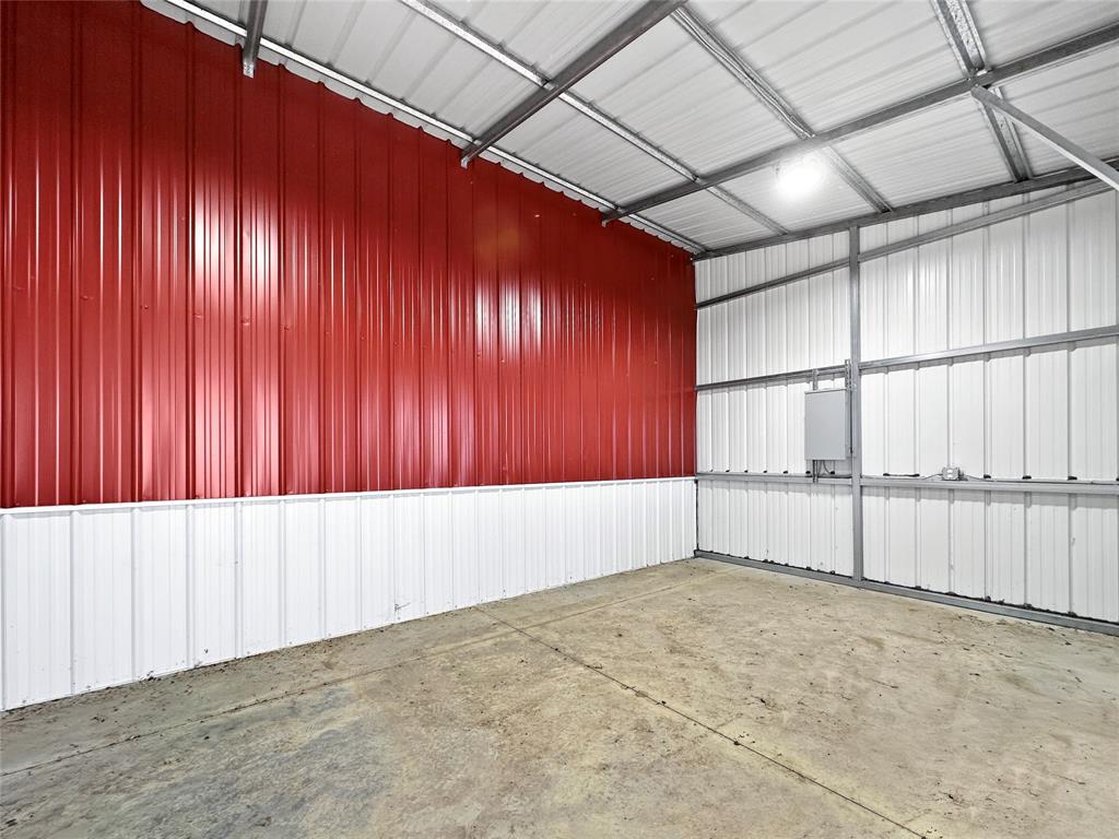 501 County Road 501 Blue Ridge, TX 75424 - Photo 14 of 27 Enclosed tack room with metal-paneled walls, concrete flooring, electrical access, and a secure door, suitable for organized equipment and supply storage.