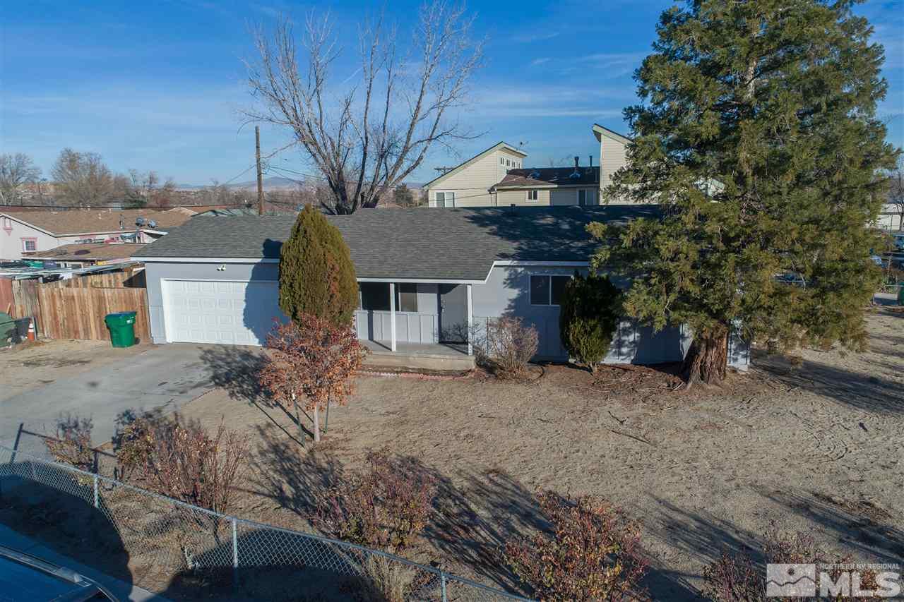 1300 Montello Street Reno, NV 89512 - Photo 1 of 1 a front view of a house with a dirt yard and a garage