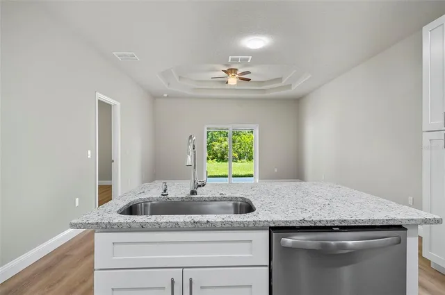 a bathroom with a granite countertop sink a window and a mirror