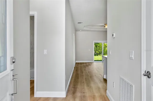 a view of a hallway with wooden floor and a hallway