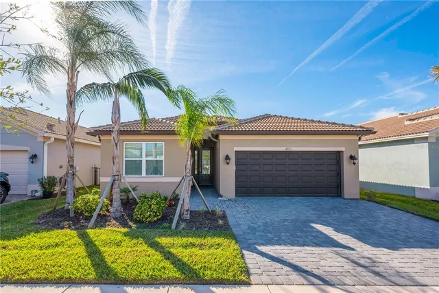 a living room with furniture kitchen view and a large window