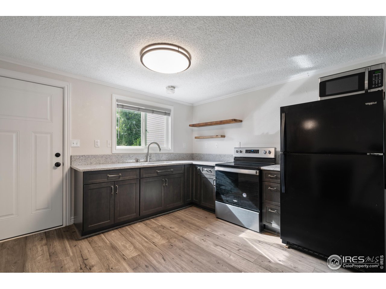 116 South Clifton Street Brush, CO 80723 - Photo 11 of 33 a kitchen with a refrigerator and a sink