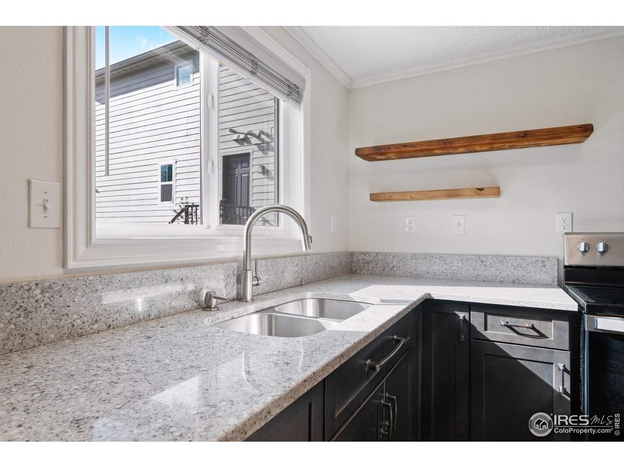 116 South Clifton Street Brush, CO 80723 - Photo 12 of 33 a kitchen with a sink cabinets and a wooden floor