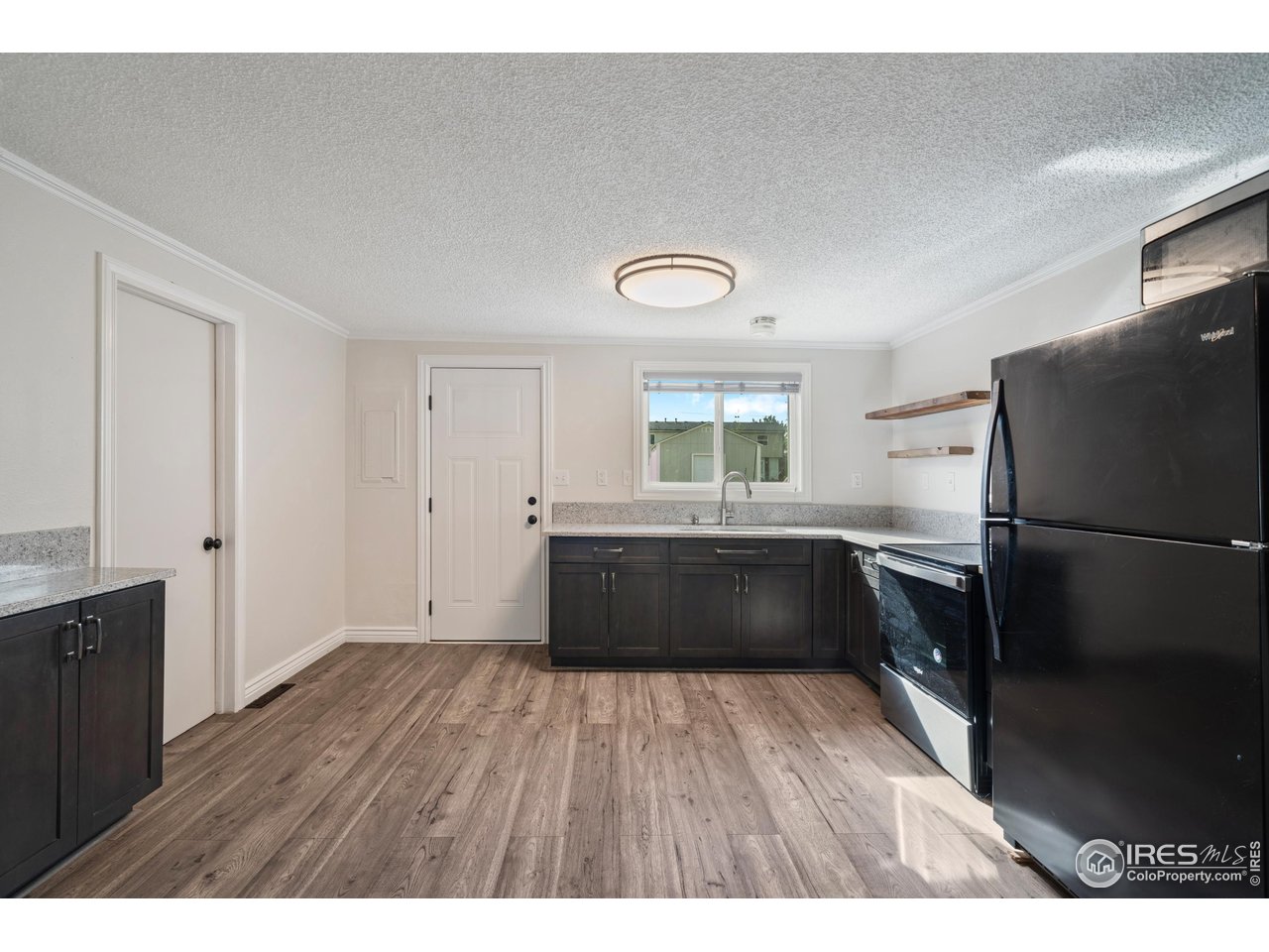 116 South Clifton Street Brush, CO 80723 - Photo 13 of 33 a kitchen with a refrigerator and a window