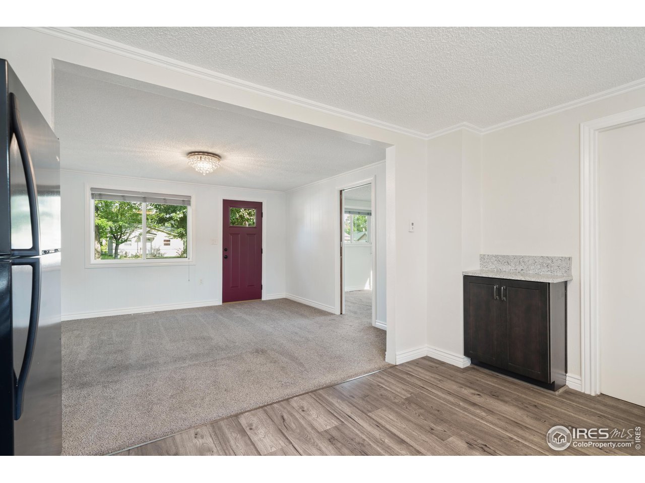 116 South Clifton Street Brush, CO 80723 - Photo 17 of 33 a view of an empty room with a window and wooden floor
