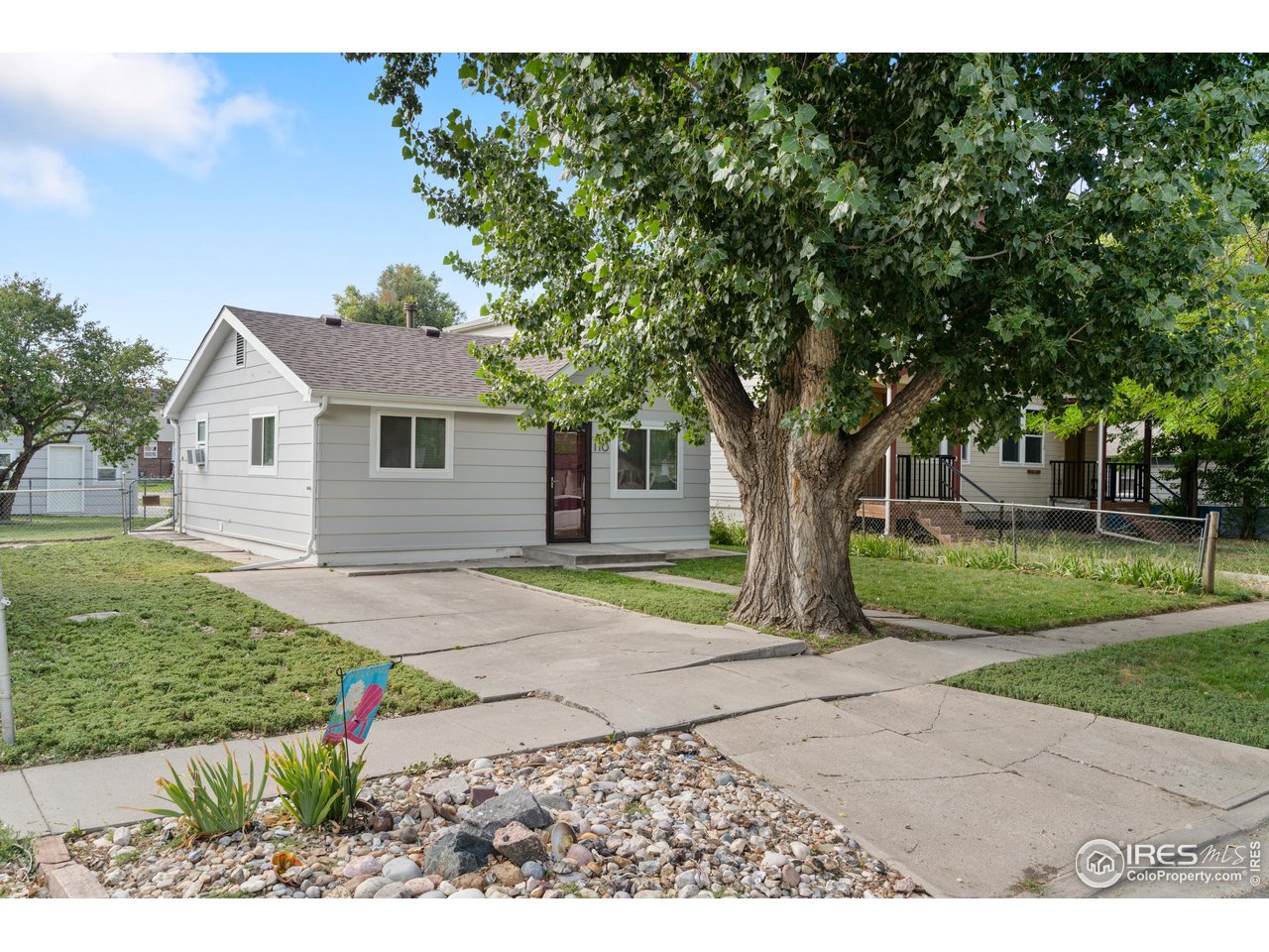 116 South Clifton Street Brush, CO 80723 - Photo 2 of 33 a front view of a house with a yard and a garage
