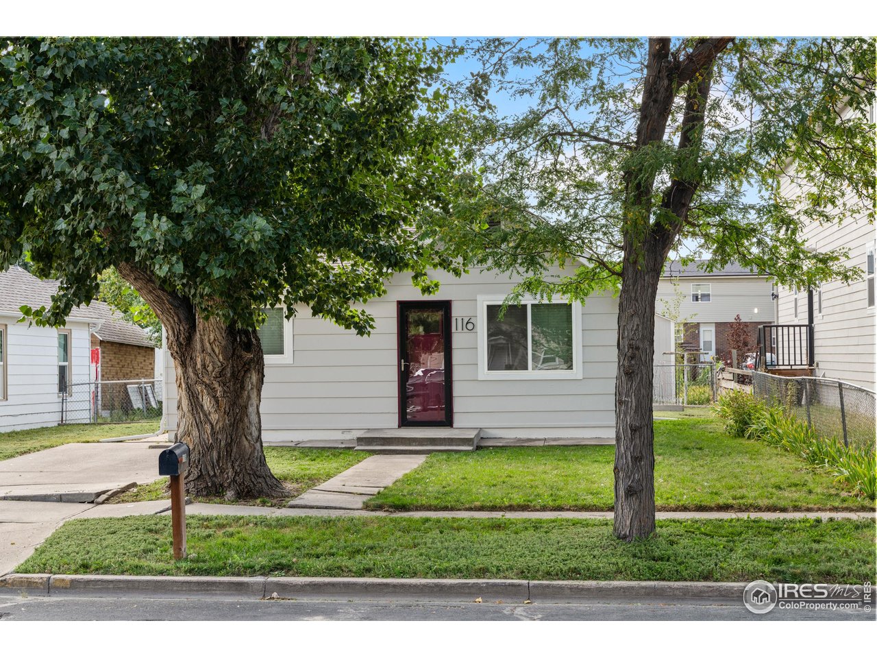 116 South Clifton Street Brush, CO 80723 - Photo 3 of 33 a front view of a house with a yard