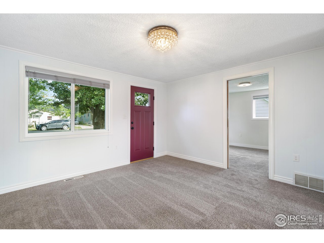 116 South Clifton Street Brush, CO 80723 - Photo 6 of 33 a view of an empty room with wooden floor and a window