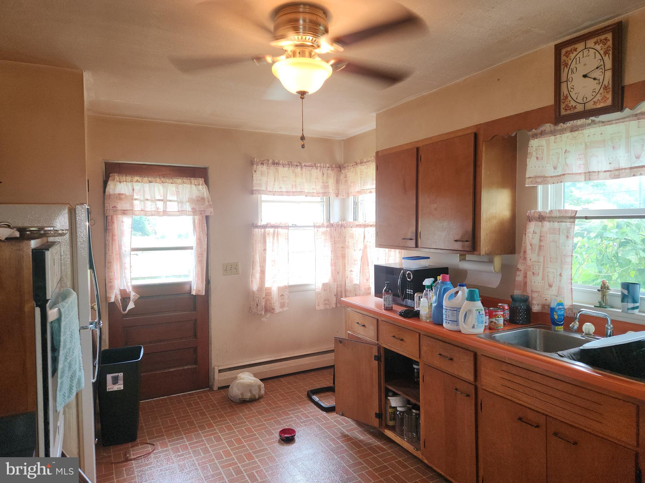 32 Bachmanville Road Hershey, PA 17033 - Photo 13 of 25 a kitchen with stainless steel appliances granite countertop a refrigerator a sink dishwasher a stove and a dining table with wooden floor