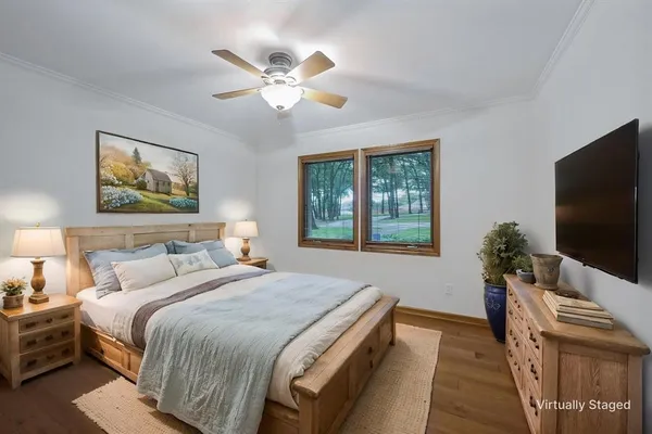 a bedroom with a bed and a flat screen tv