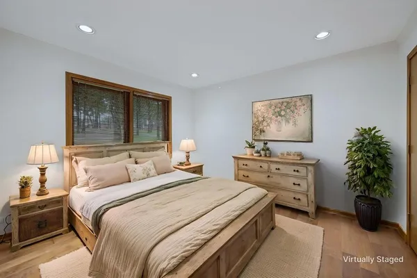 a bedroom with a bed and a potted plant