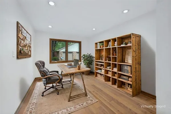 a workspace with wooden floor and a book shelf