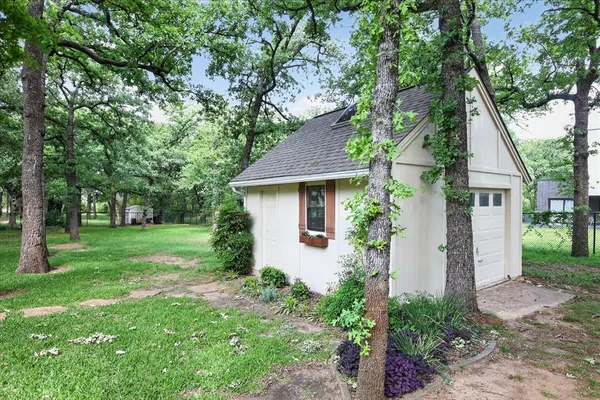 a front view of house with a garden